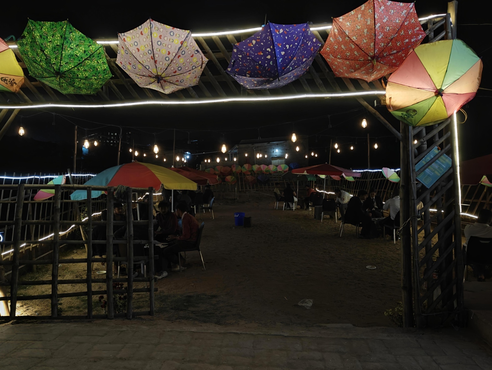 D2S Dehradun Cafe - Colorful umbrella ceiling with string lights